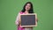 Mature beautiful Indian woman showing blackboard while thinking