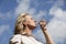 Mature blond woman drinking water