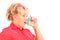 Mature blond woman taking asthma treatment