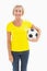 Mature blonde holding football smiling at camera