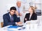 Mature boss is chastising employees because of uncompleted work