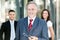 Mature businessman in front of a group of business people outdoor