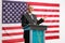 Mature businessman giving a speech on a podium in front of USA flag