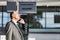 Mature businessman making report on his delayed flight while standing at his boarding gate in airport