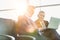 Mature businessman reading news paper while the other businessman is talking on smartphone in airport