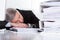 Mature businessman sleeping at desk