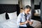 Mature businessman with smartphone in a hotel room.