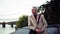 Mature businessman with suitcase standing by river Vltava in Prague city.