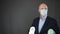 Mature businessman wearing facial mask holding toilet paper. Man in protective mask lockdown holding toilet paper rolls