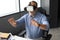 Mature businessman wearing a VR headset while sitting in modern office. Change the way you see and experience the world