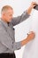 Mature businessman writing at empty flip chart