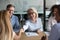 Mature businesswoman shaking hand of business partner at meeting