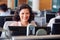 Mature Businesswoman Wearing Telephone Headset Talking To Caller In Customer Services Department