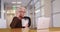 Mature Caucasian woman on lunch break at work eating Chinese takeout in office