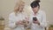 Mature Caucasian women teaching her friend using smart phone. Portrait of two senior ladies in white shirts spending