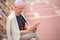 Mature charming woman sitting on the chair with tablet