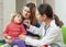 Mature children\'s doctor examining baby