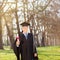 Mature college graduate holding a diploma in park