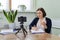 Mature confident woman counselor recording video stream, online consultation