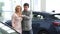 Mature couple choosing a new automobile at the dealership salon