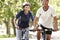 Mature Couple Cycling Through Park