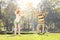 Mature couple exercising with hula hoops in park