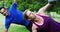 Mature couple exercising with kettlebell in the park