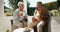 Mature couple, happiness and coffee in garden on retirement, bonding and conversation with cookies. Mexican seniors