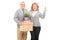 Mature couple holding moving boxes and keys