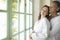 Mature Couple hugging by garden doors.