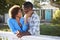 Mature Couple Leaning On Back Yard Fence