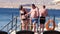 Mature couple with obesity on a pontoon. Overweight man and woman overlooking the sea. Junk food, obesity, diet and