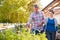 Mature Couple Outdoors Choosing Plants To Buy At Garden Center