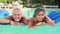 Mature Couple Relaxing On Airbed In Swimming Pool