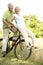 Mature couple riding bike in countryside