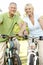 Mature couple riding bikes