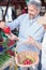 Mature couple shopping groceries in a local organic open air marketplace