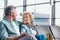 Mature couple sitting while waiting for their flight in airport