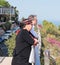 Mature couple standing on the terrace and looking dreamily into the distance in Haifa, Israel