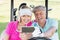 Mature couple taking selfie while sitting in golf buggy