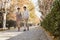 Mature Couple Talking a Walk in the Park in Autumn