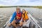 Mature couple tourists travel on an inflatable boat with a motor on the Volga river