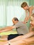 Mature couple with trainer at gym