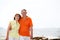 Mature couple walking along the beach.