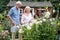 Mature Couple Working In Flower Beds In Garden At Home