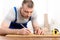 Mature Craftsman Working Making Furniture Measuring Wooden Board Indoors