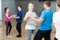 Mature dancing couple during group class