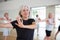 Mature dancing woman practices energetic swing