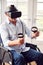 Mature Disabled Man In Wheelchair At Home Wearing Virtual Reality Headset Holding Gaming Controllers