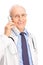 Mature doctor speaking on a telephone and smiling